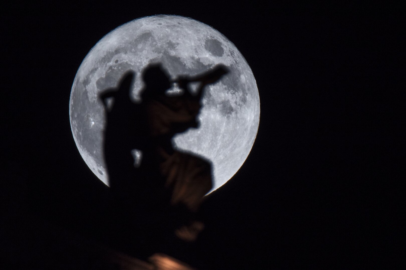 It's a photo of a super moon with inside an angel using a trumpet. The angel is a sculpture from the basilica Notre Dame de Ia Garde in Marseille, south of France