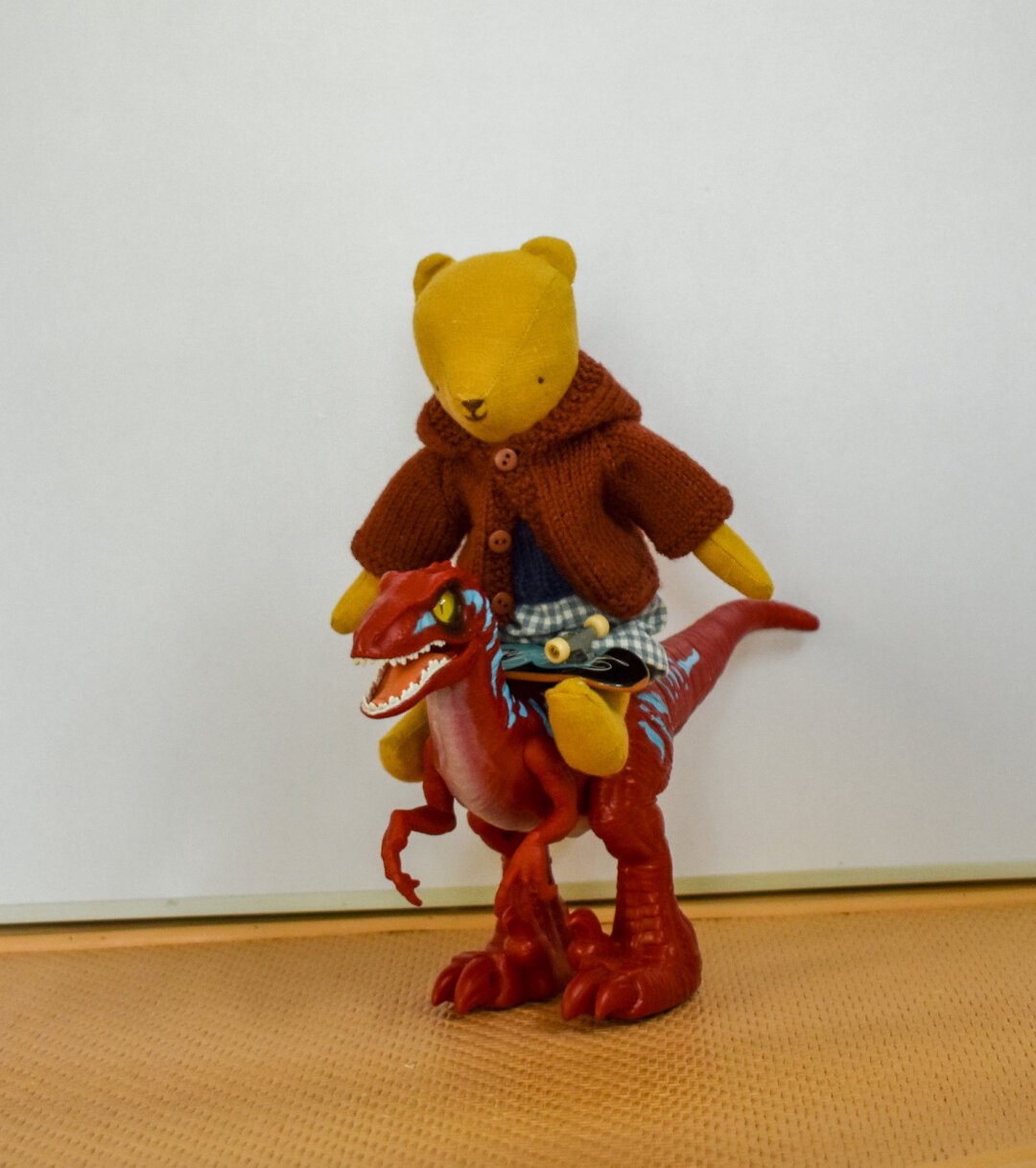 Teddy Junior is riding his T Rex to the skate park