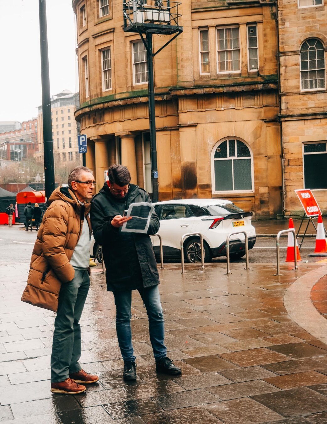 Two men consult a map