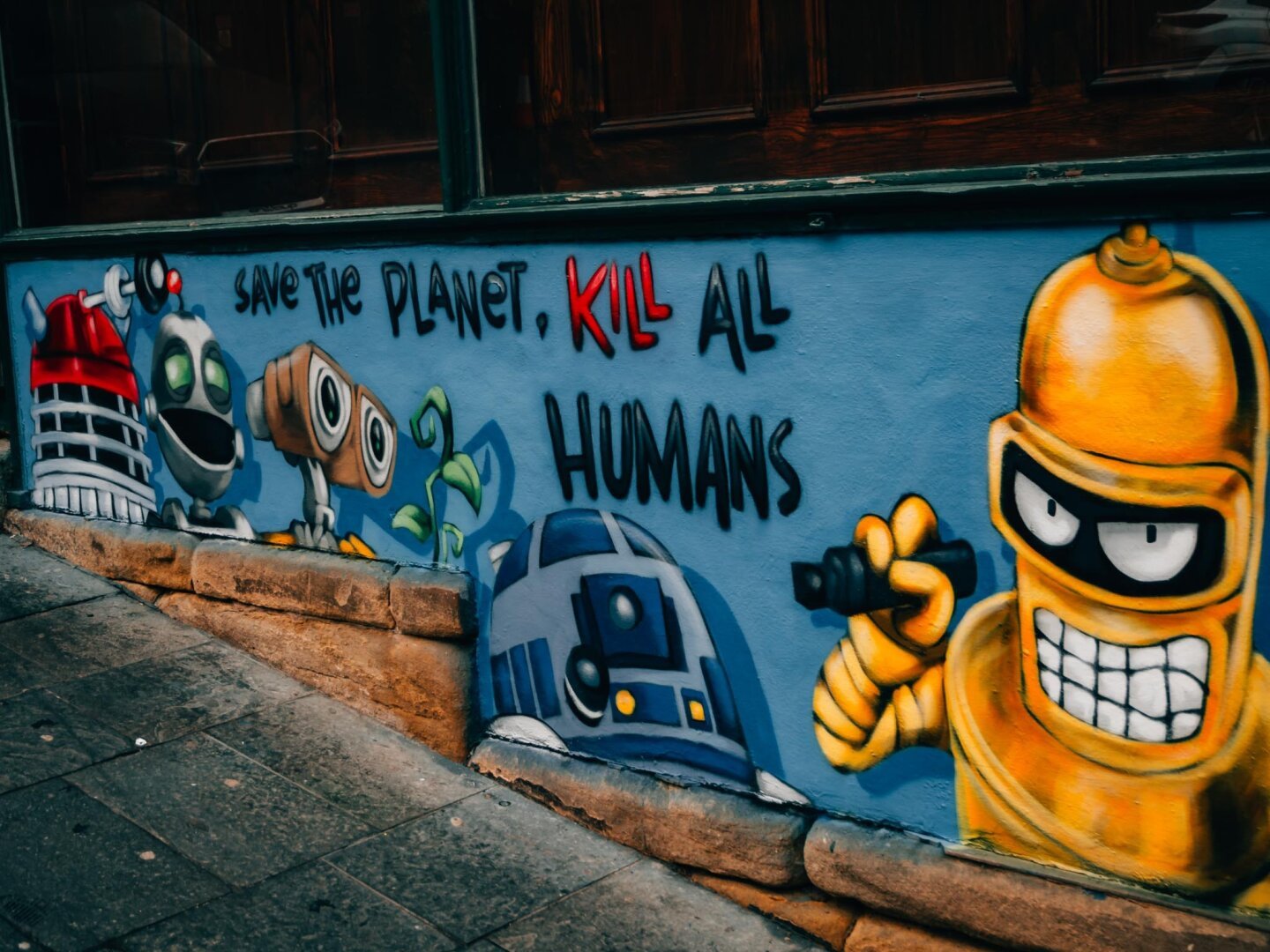 Graffiti art, robots from media with the text, 'save the plant, kill all humans'