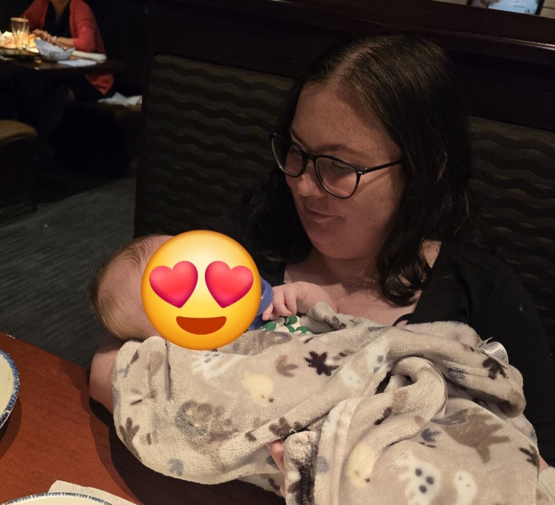 Woman looking at baby while holding him