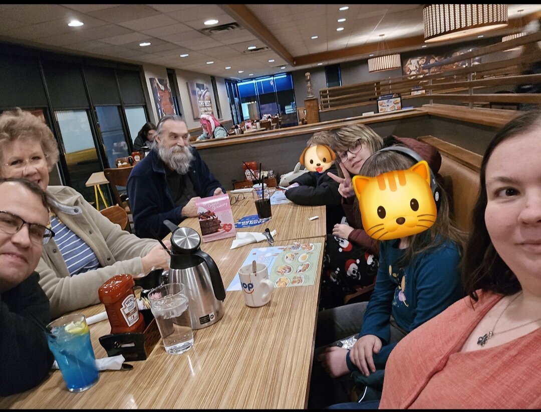 Family sitting at table in restaurant