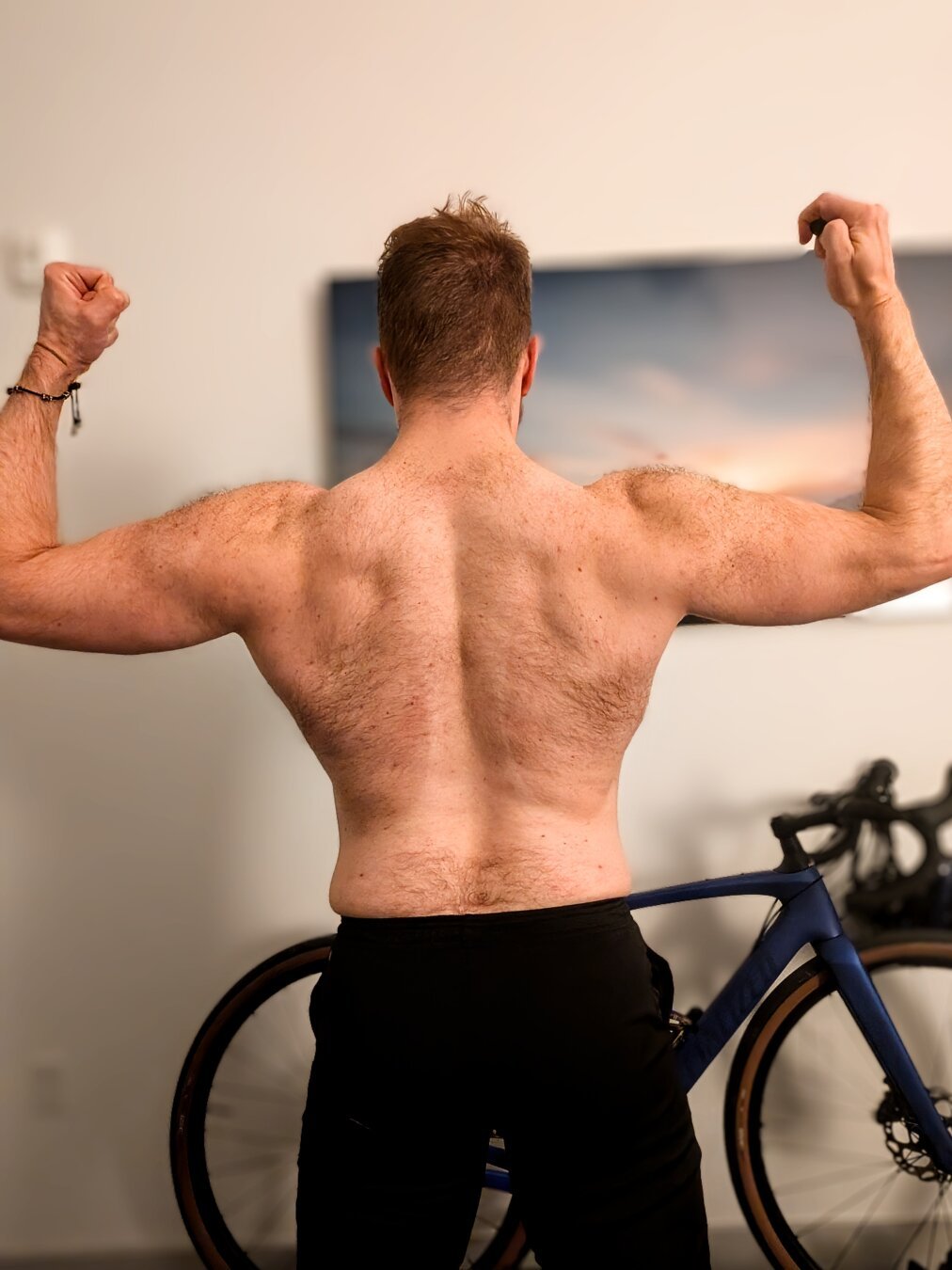 Muscle guy flexing his fuzzy back