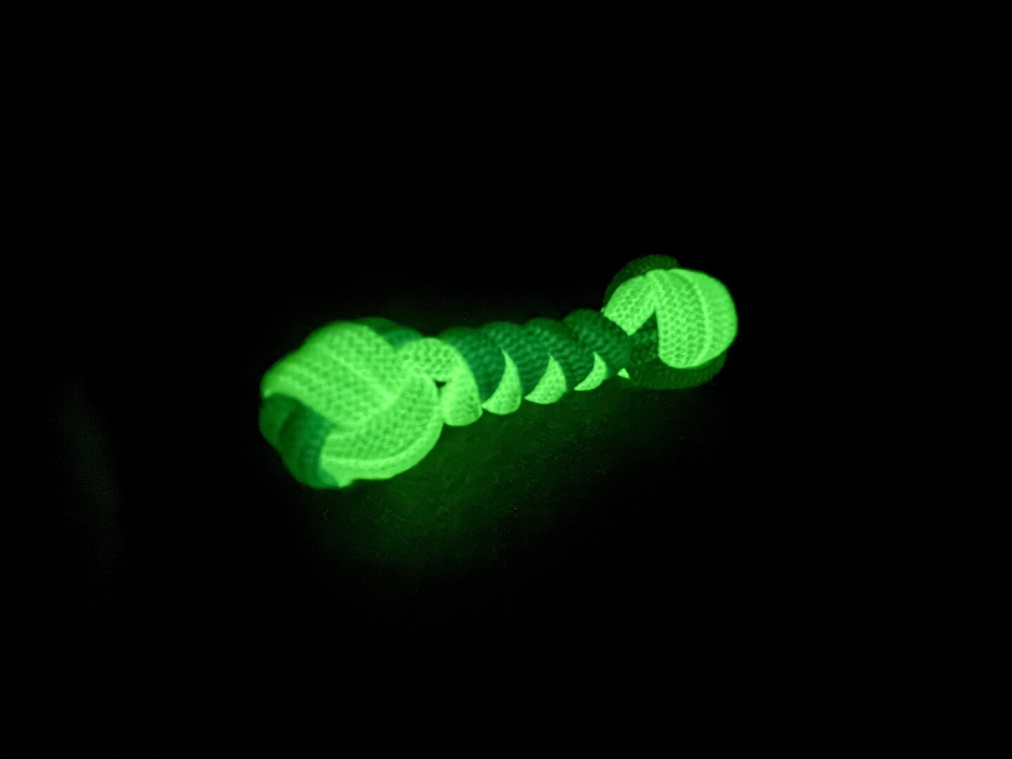 A glow in the dark knuckle roller woven out of paracord