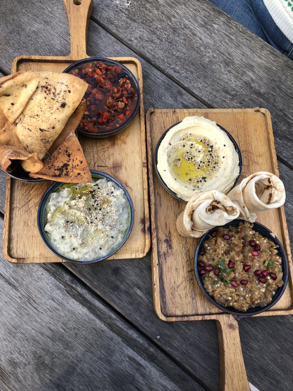 Plate with crackers and flatbread with hummus, muhammara, moutabal and baba ganoush