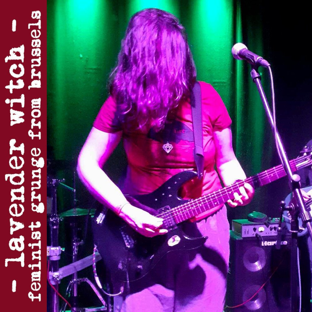 Guitarist with dark blue electric guitar playing on a stage with green curtains. Guitarist has dark brown wavy hair in front of face and red T-shirt. Text says: Lavender Witch - feminist grunge from Brussels.