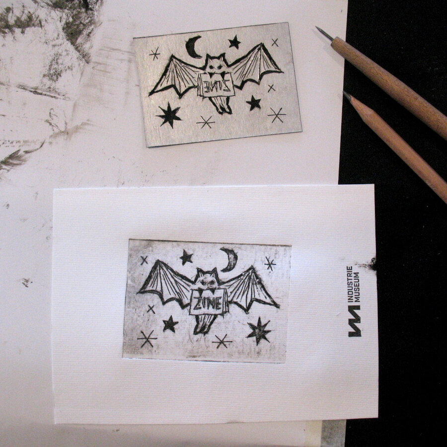Engraving of a bat with a zine in its mouth and star and a moon around it: both the original engraving is pictured as well as the print of the engraving.