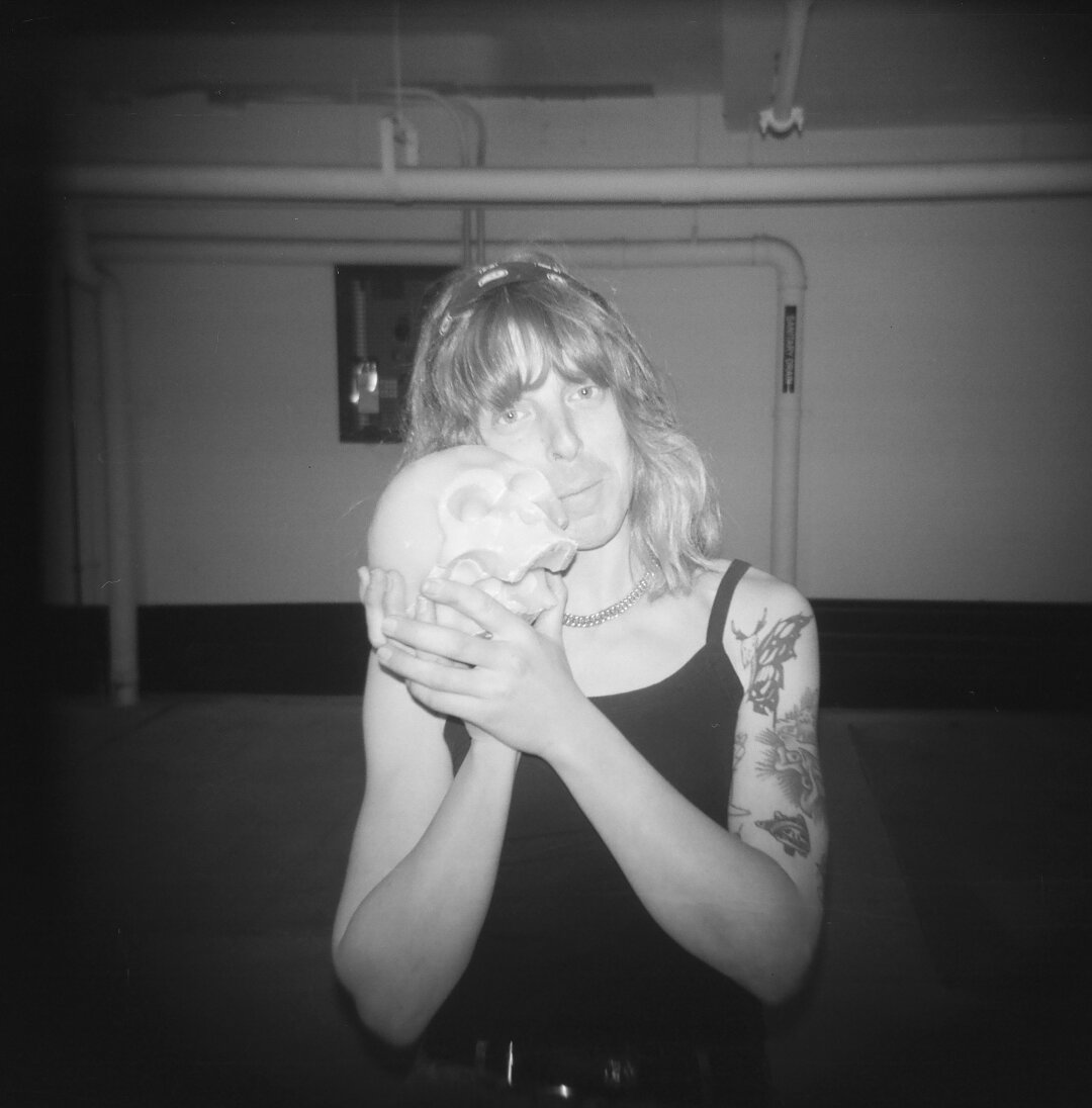 melody and a wax skull in a parking garage. holga 120cfn kentmere 400