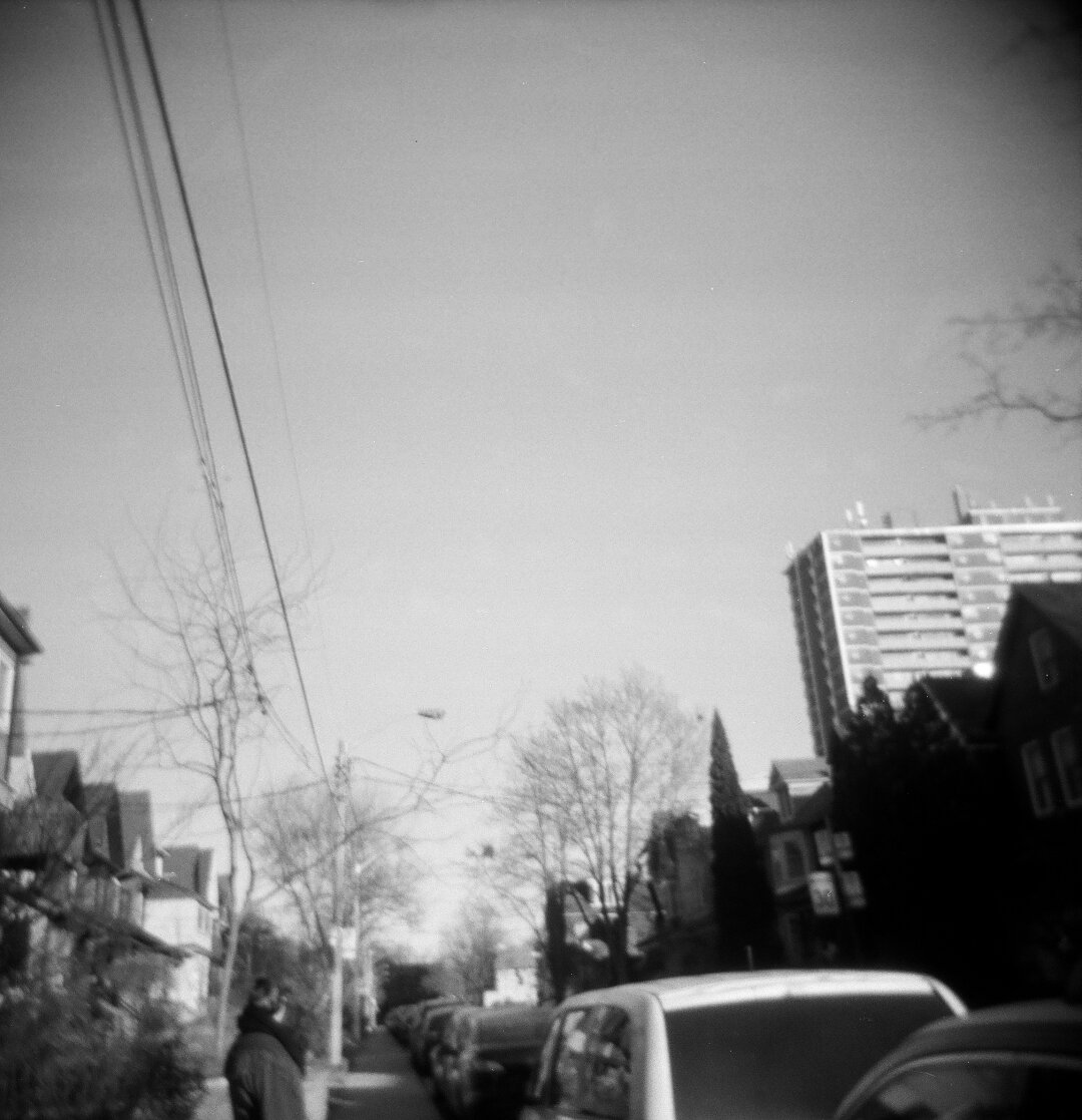 blurry shot looking down my street at all the houses. holga 120cfn kentmere 400