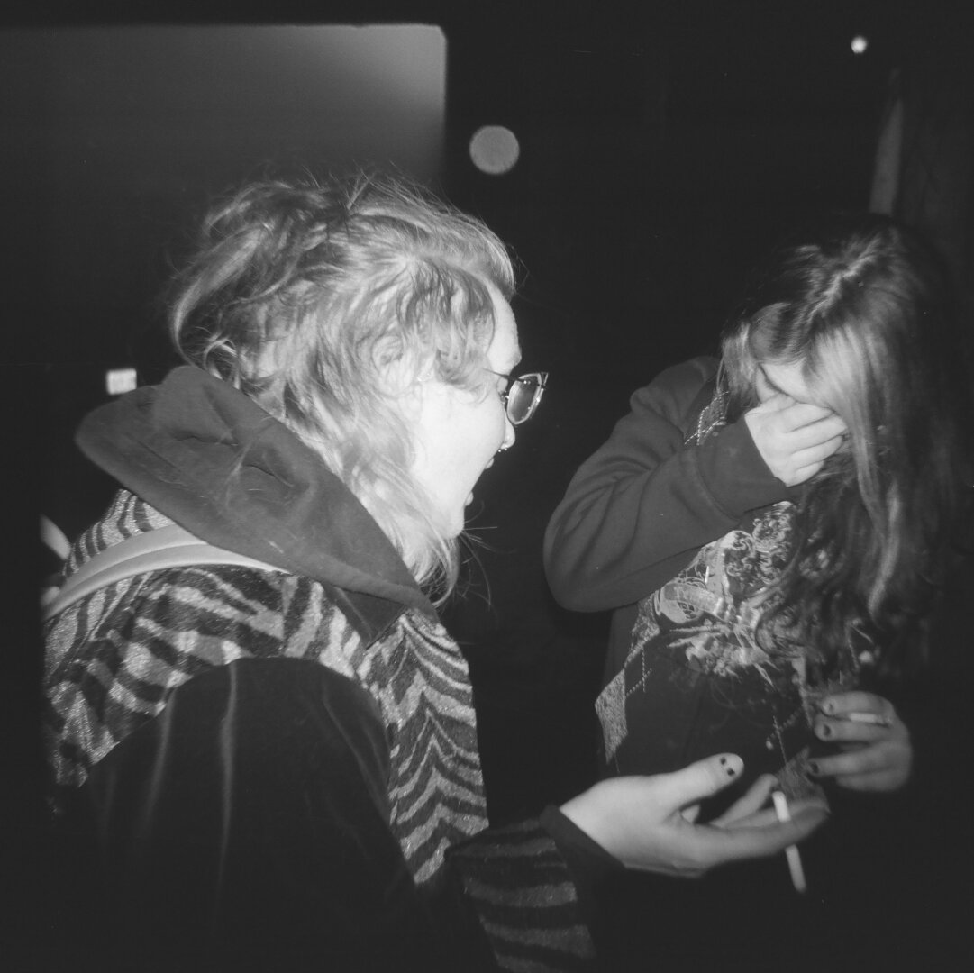 zel and zoey engaged in deep discussion. holga 120cfn kentmere 400
