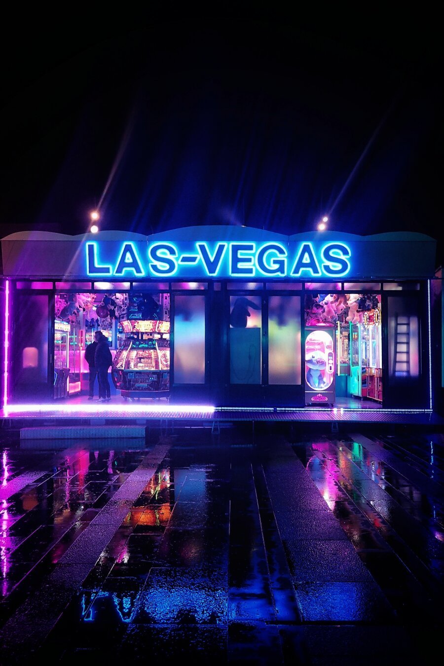 Fancy fair slot machines in magenta and blue neon lights with a 