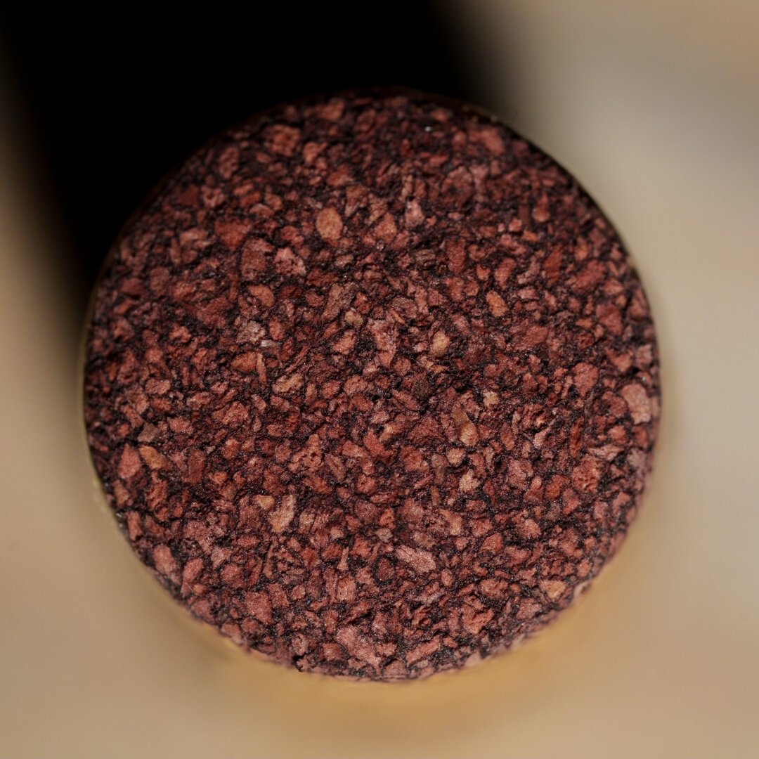 The bottom of a wine cork from above.