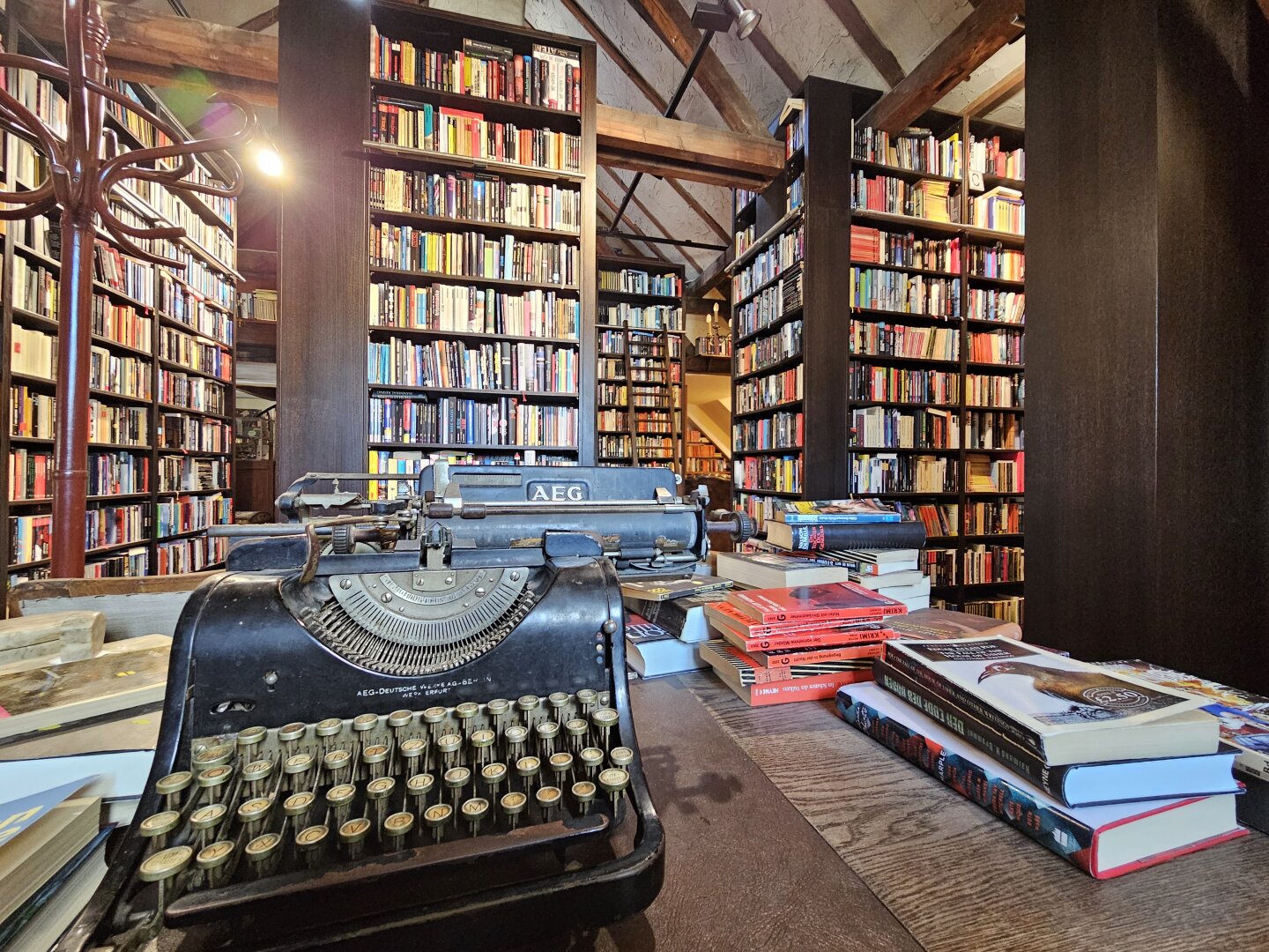 Room filled with bookcases and in the foreground and old typewriter
