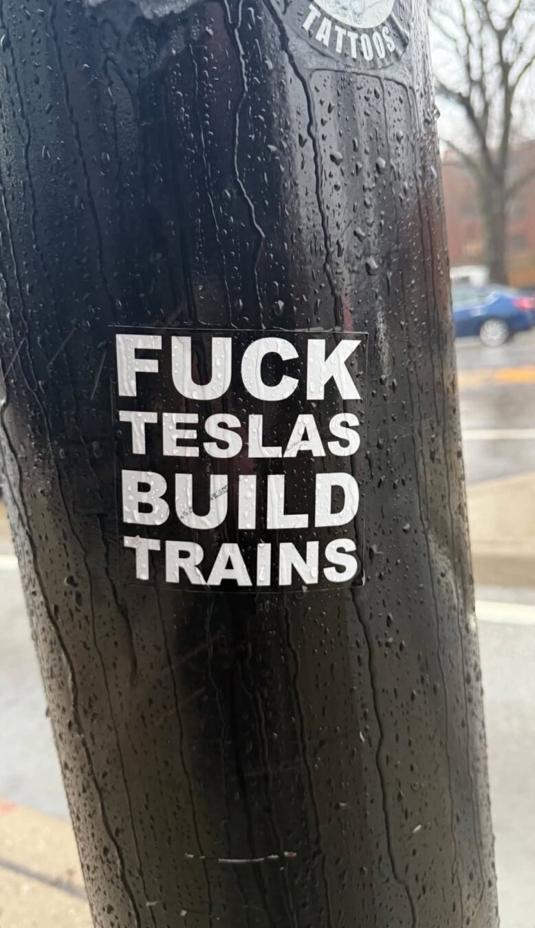 Sticker with text "Fuck Teslas build trains"