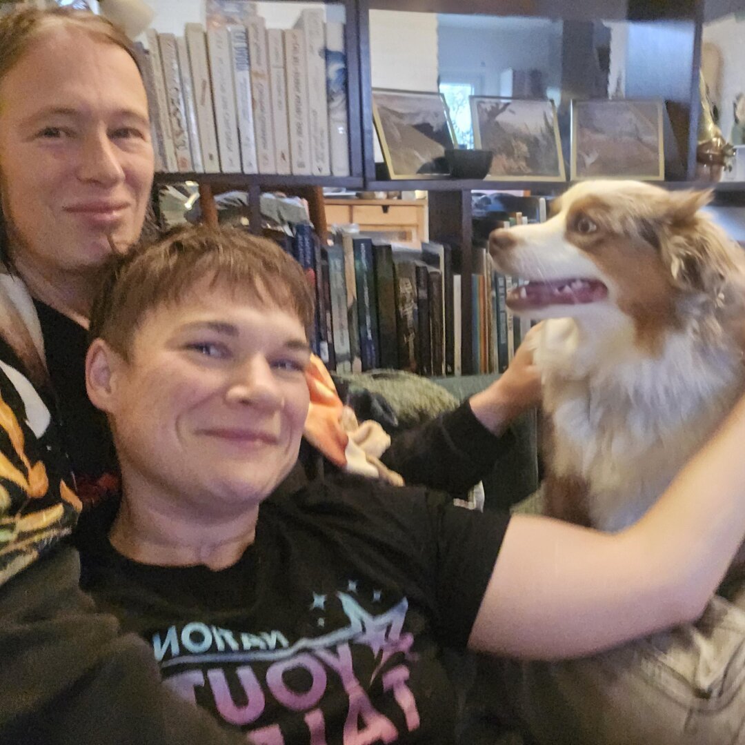 A photo of me, a black and white cat, sitting on top of my human's lap