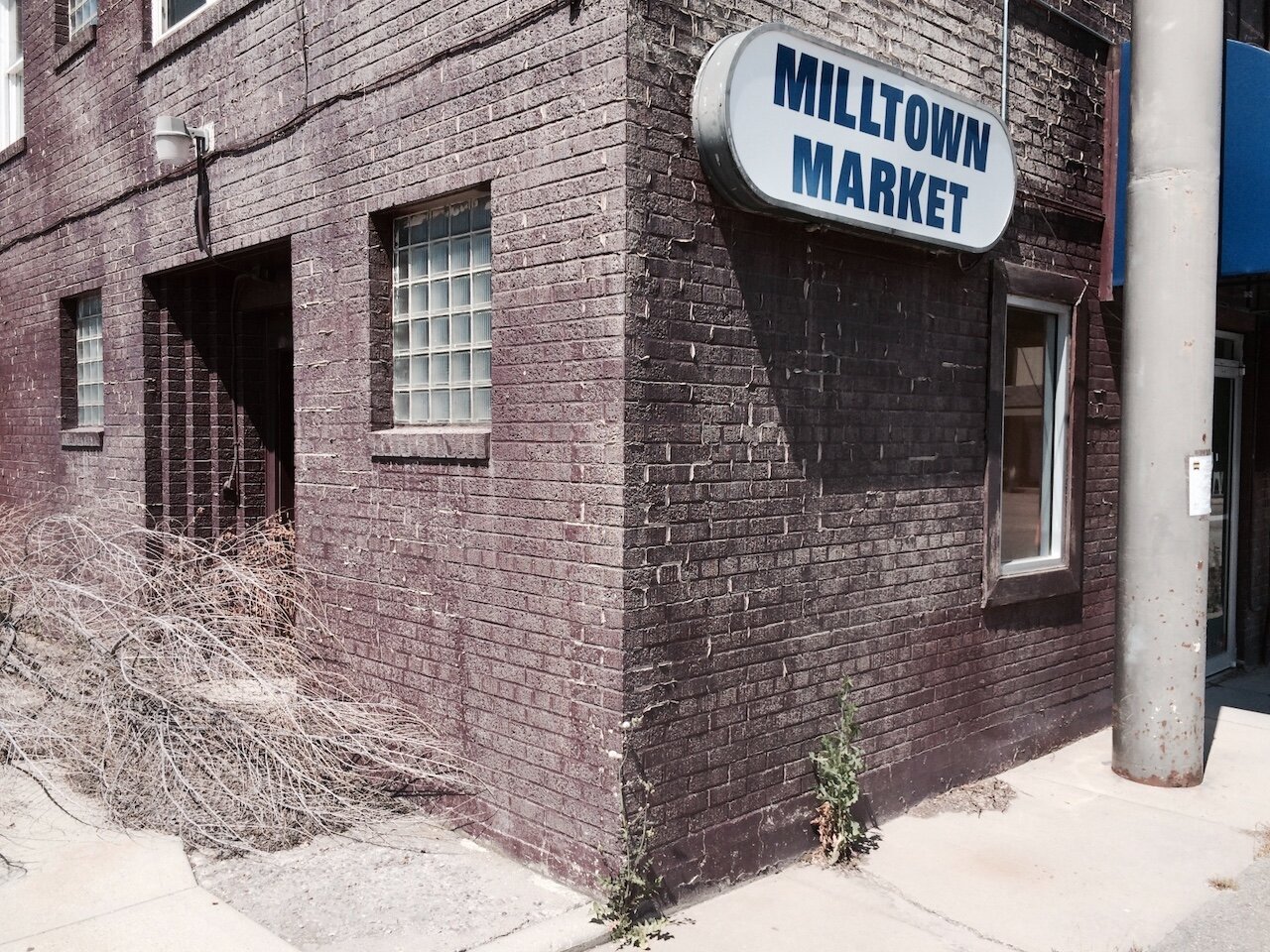 Title: Extractors Abandon Local Market for More Money Elsewhere

Alt Text: Photography of a grocery store, the Milltown Market. Built with brick, including glass brick windows, it's closed.

Photographer: Marshall Mayer aka @AuthenticPhoto

Date and Time: July 11, 2014 at 2:55 pm

Location: on SR 200, Milltown, MT  USA

License: CC BY-NC-ND 4.0

Caption: Milltown, MT was, until recently, a company town completely dependent on a lumber mill. After the timber companies left for the pulp forests of the Southeast, the mill building became a Bitcoin server farm. Hydro energy provided in part by a nearby dam was damned cheap. Faraway capitalists have forever hollowed out and will forever hollow out this town.

Hashtags: #BitcoinMine #SagebrushRebellion #CompanyTown #CapitalFlight #SuperFundSite #ExportedProfits #ServerFarm #Extraction #Authentic #Photography

Source: https://take-note.com/note-takers/marshall--mayer/notes/extractors-abandon-local-market-for-more-money-elsewhere/view