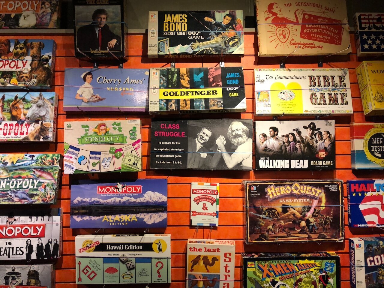 Title: Class Struggle Is Renters Overpowering Landlords

Alt Text: Photograph of several board games that are displayed on a wall. Prominent among them are 