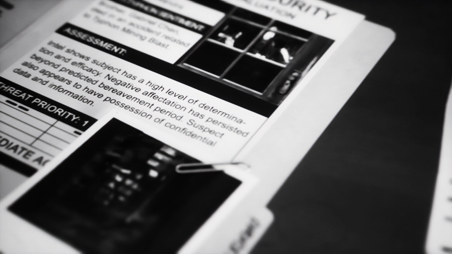 An opened dossier containing confidential information on Alex and her friends.