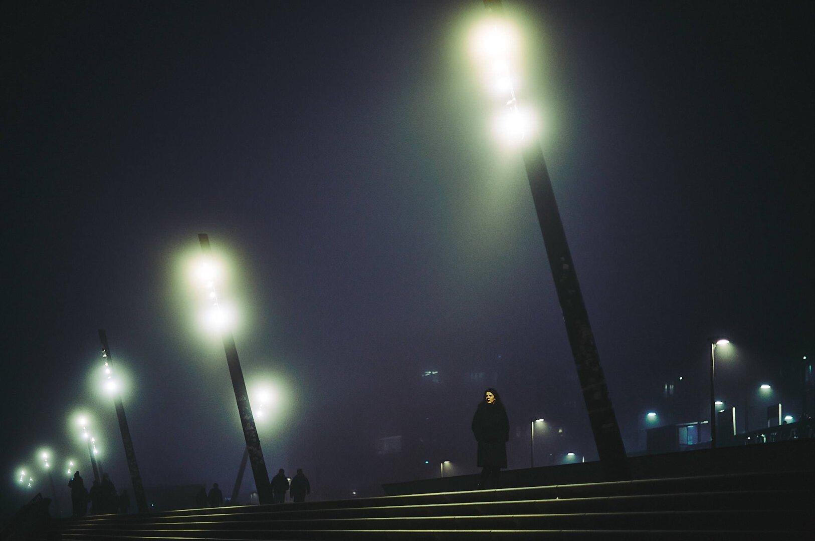 Lonesome woman at a foggy night in Hamburg.