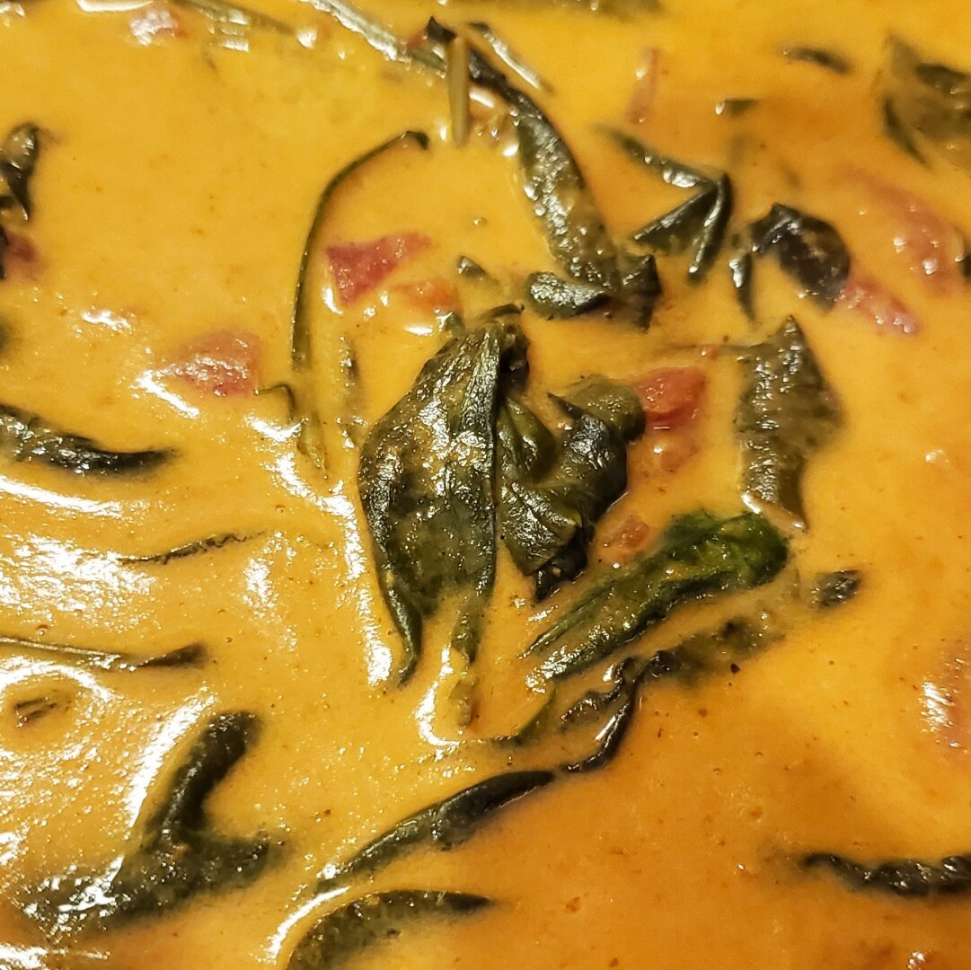 Coconut milk, diced tomatoes, butter chicken sauce, and spinach, waiting for the mushrooms, onions, garlic, and chicken.