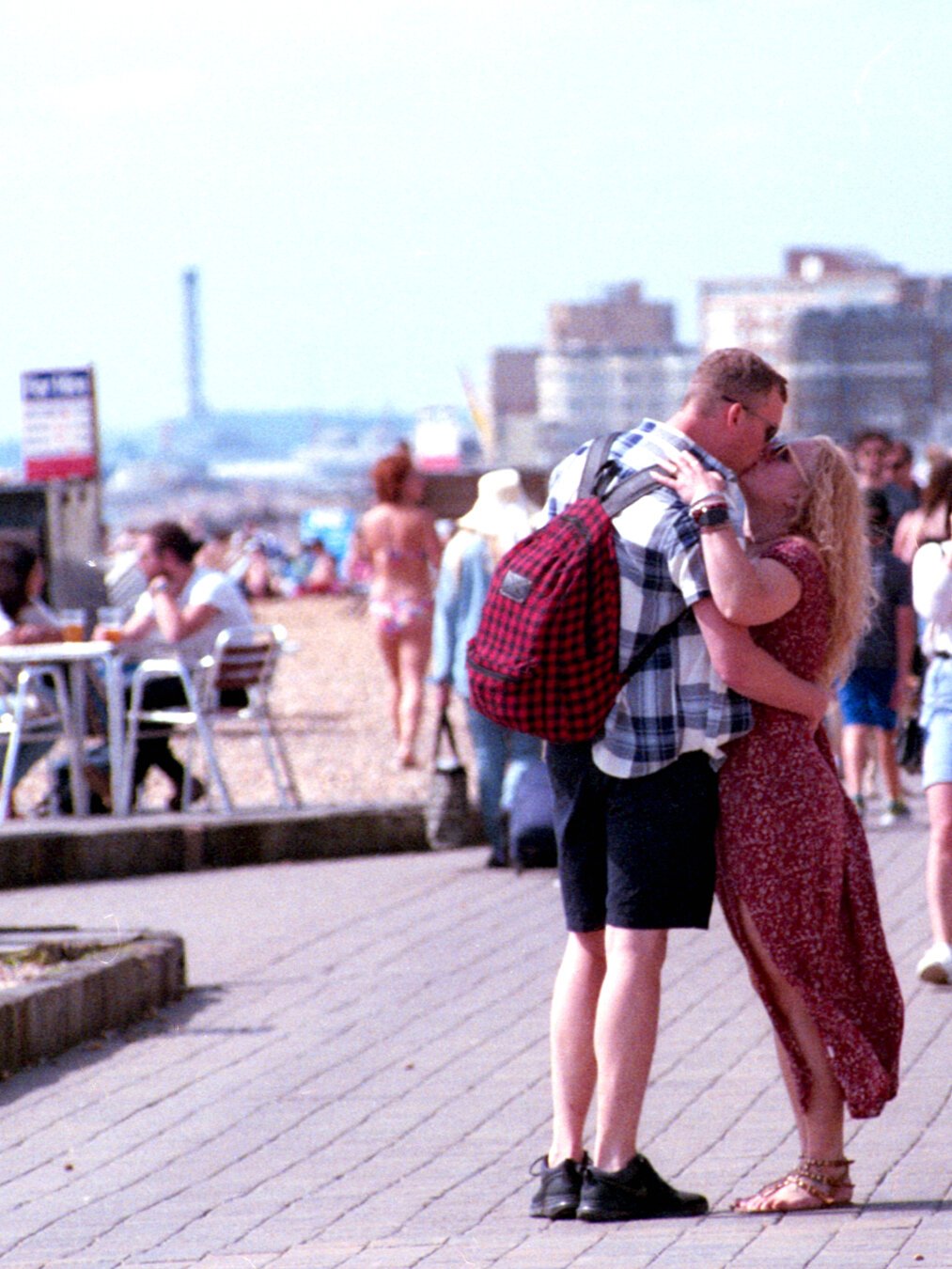 two people kissing each other on the Brighton Seafront