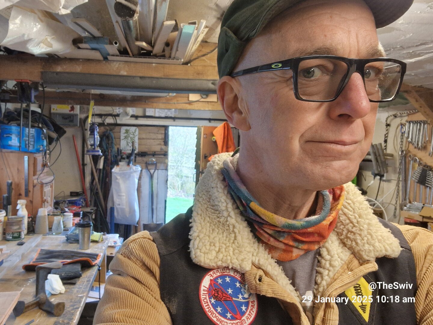 Cheerful old man smiling in his workshop