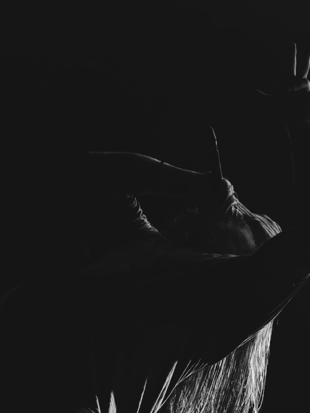 Ilkka Laaksonen performing screaming vocals for Ashen Tomb on stage in a theatrical pose