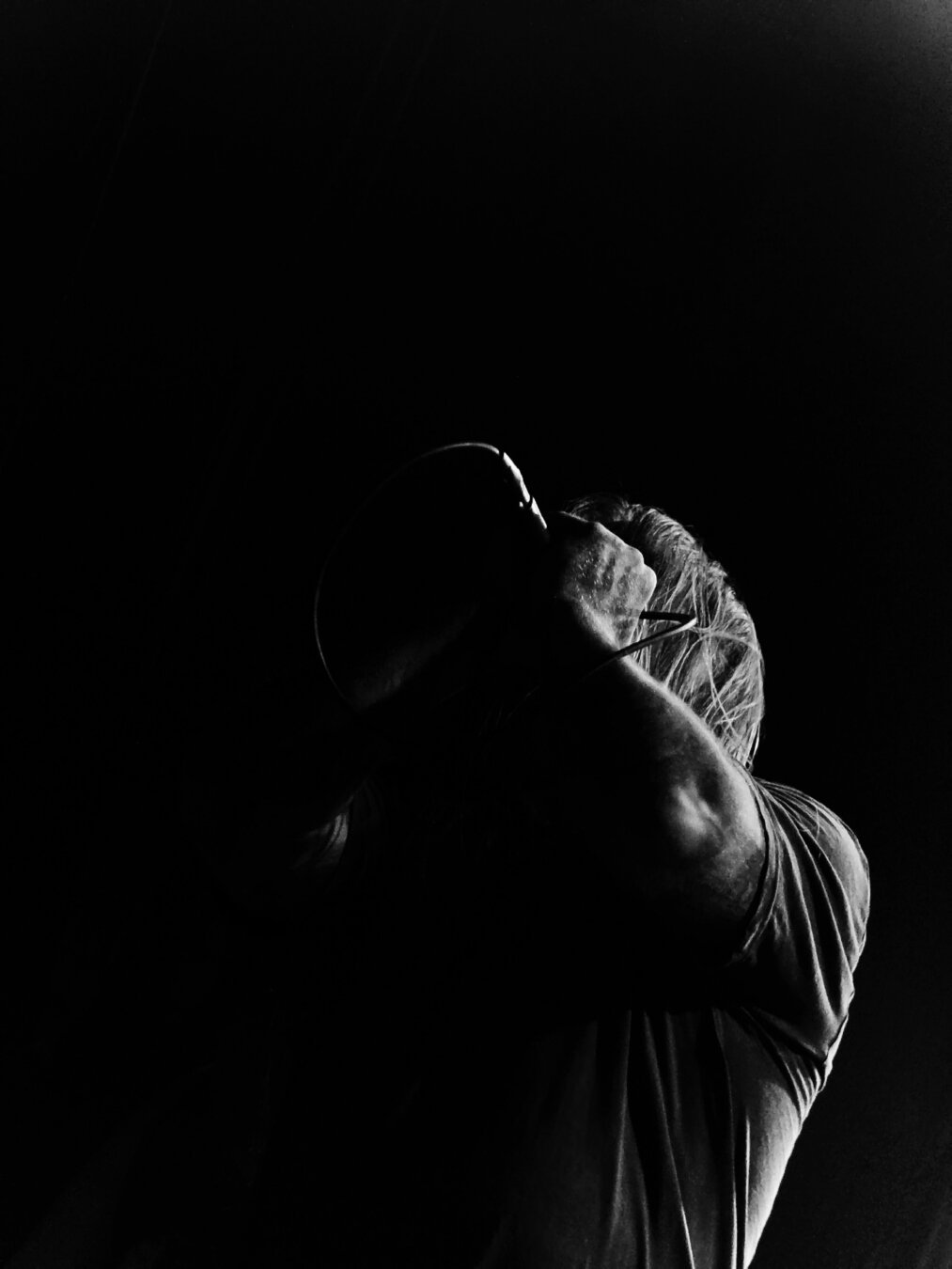 Ilkka Laaksonen, vocalist for Ashen Tomb, doing intense growling vocals on stage