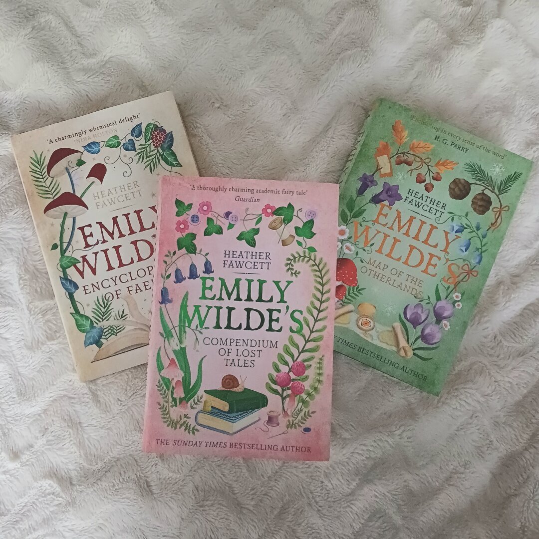 A flatlay of the three Emily Wilde's books by Heather Fawcett