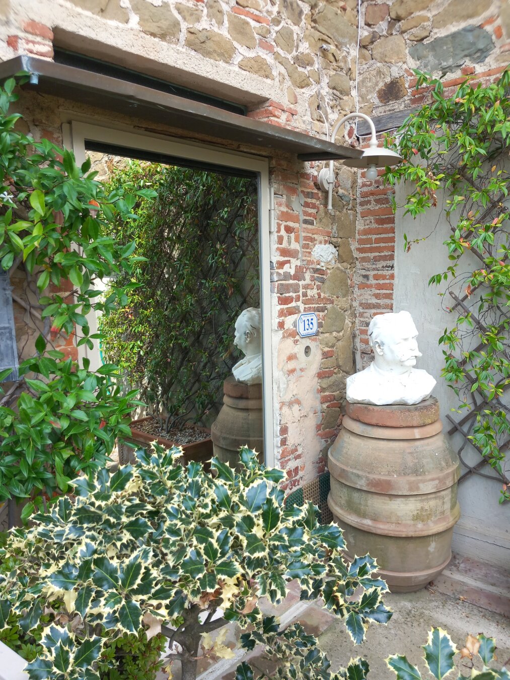 House entrance with plats and statue