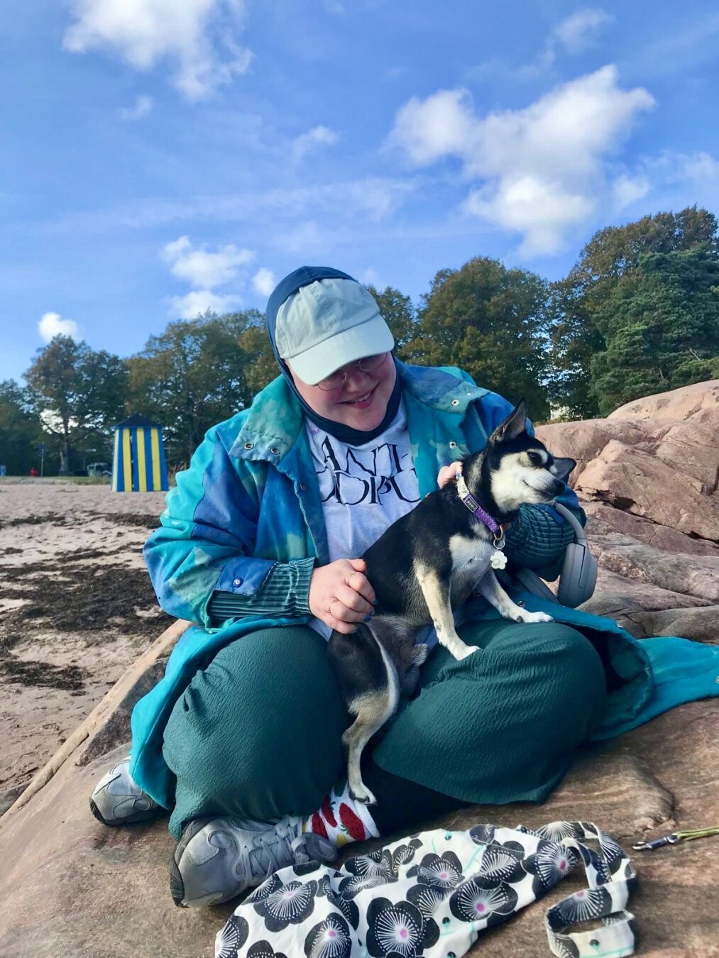 a photo of Isa with a small dog Charlie who enjoys being petted