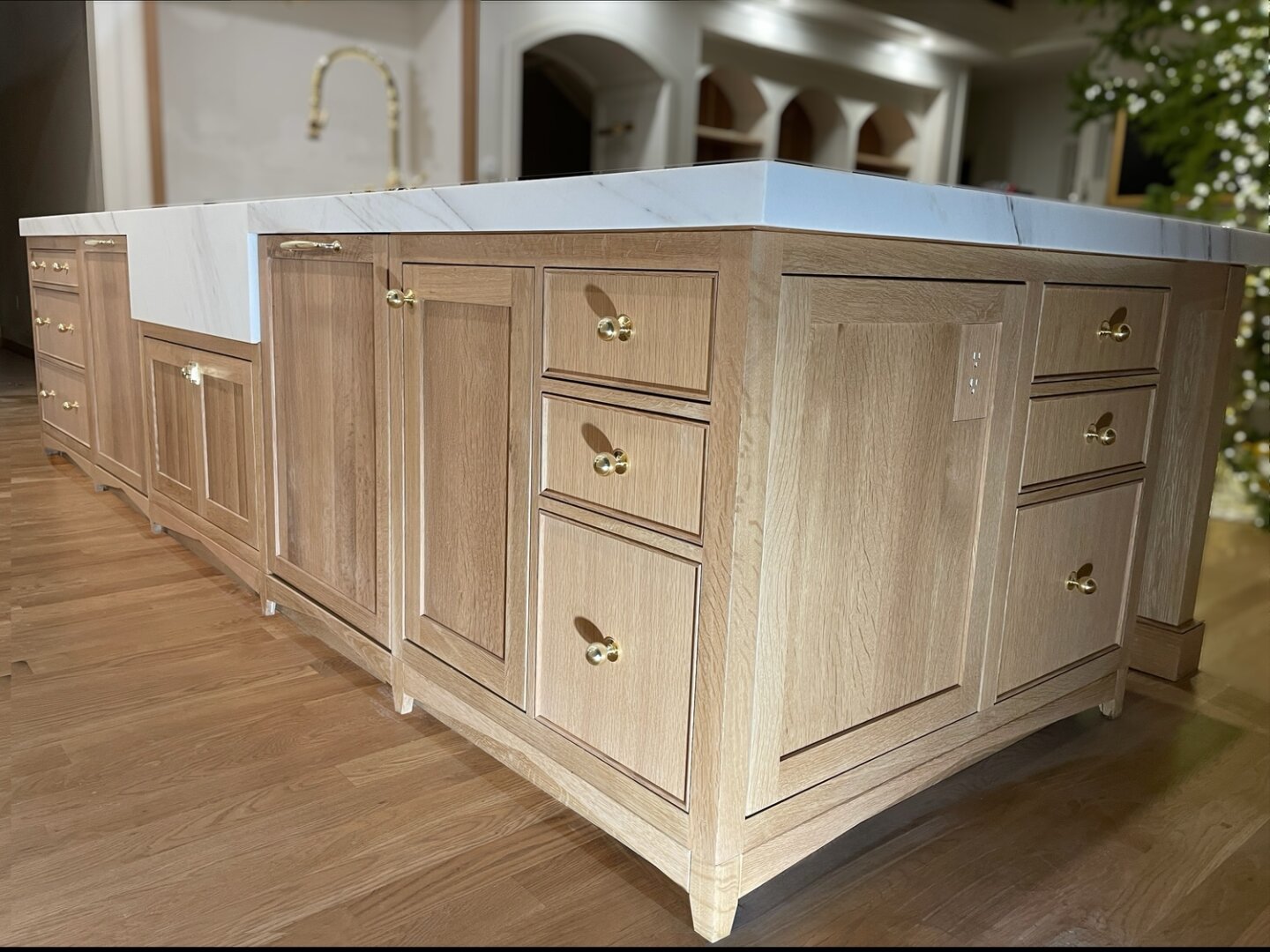 White oak kitchen island with inset fronts and a marble top.