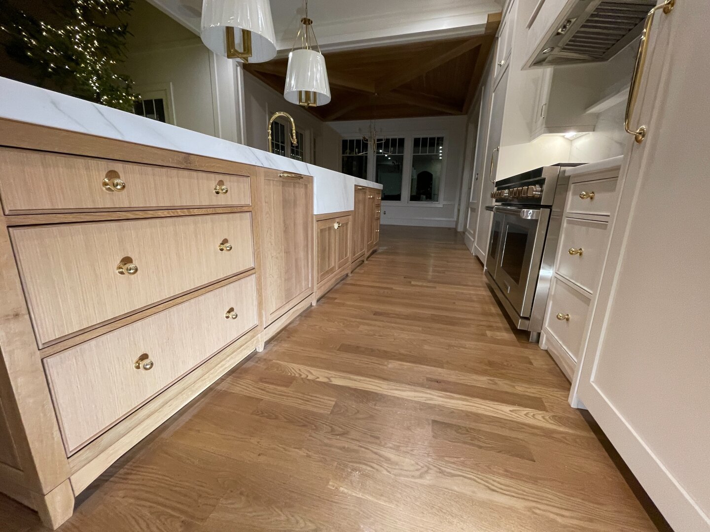 White oak kitchen island with inset fronts and a marble top.