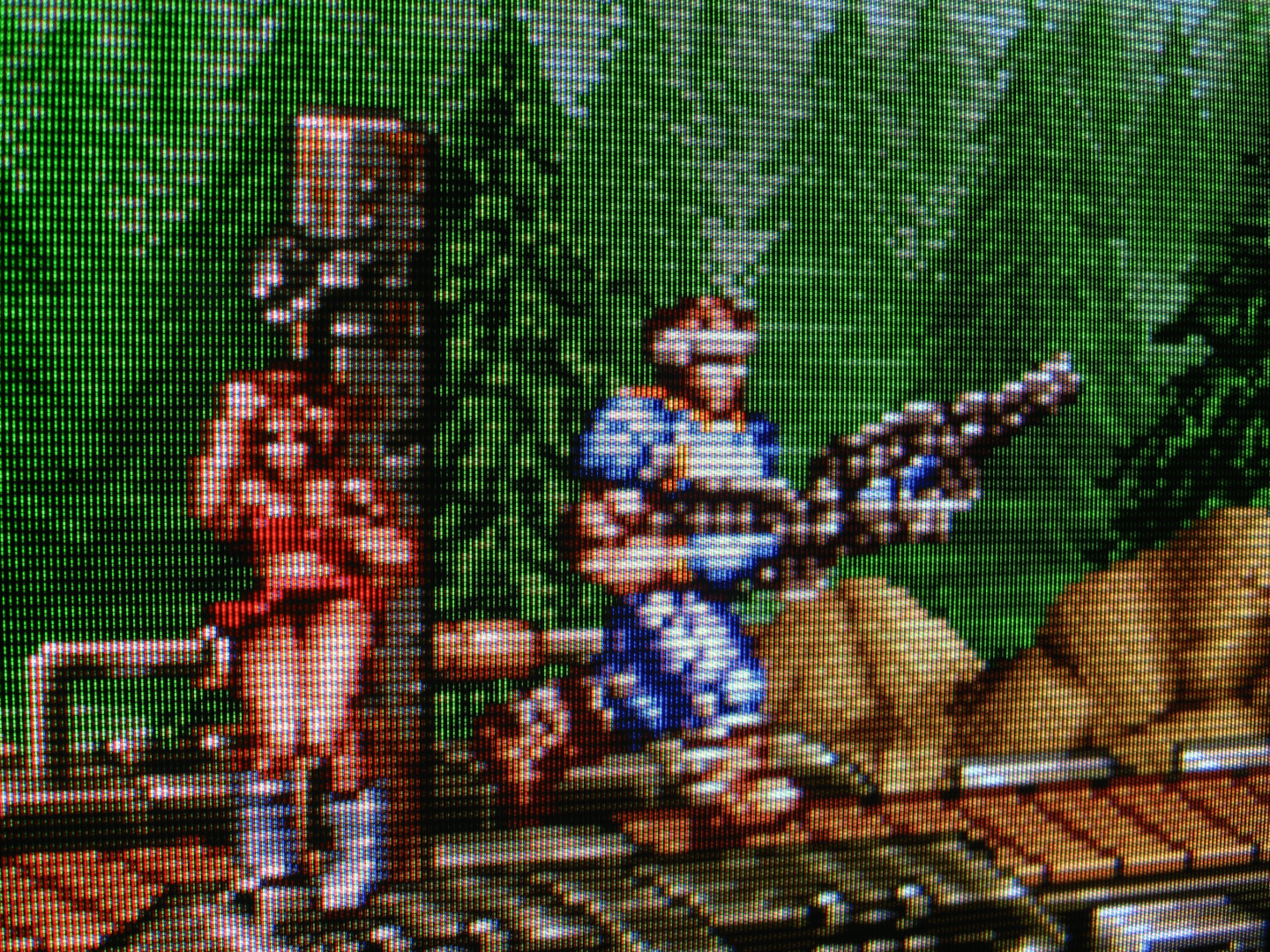 Brave GunForce 2 Guy jogs along a moving train car, huge rifles in each hand, having just freed a babe from a pole. The prevalence of babes tied to poles in this universe suggests an extremely upsetting material reality. Best not to think about it.