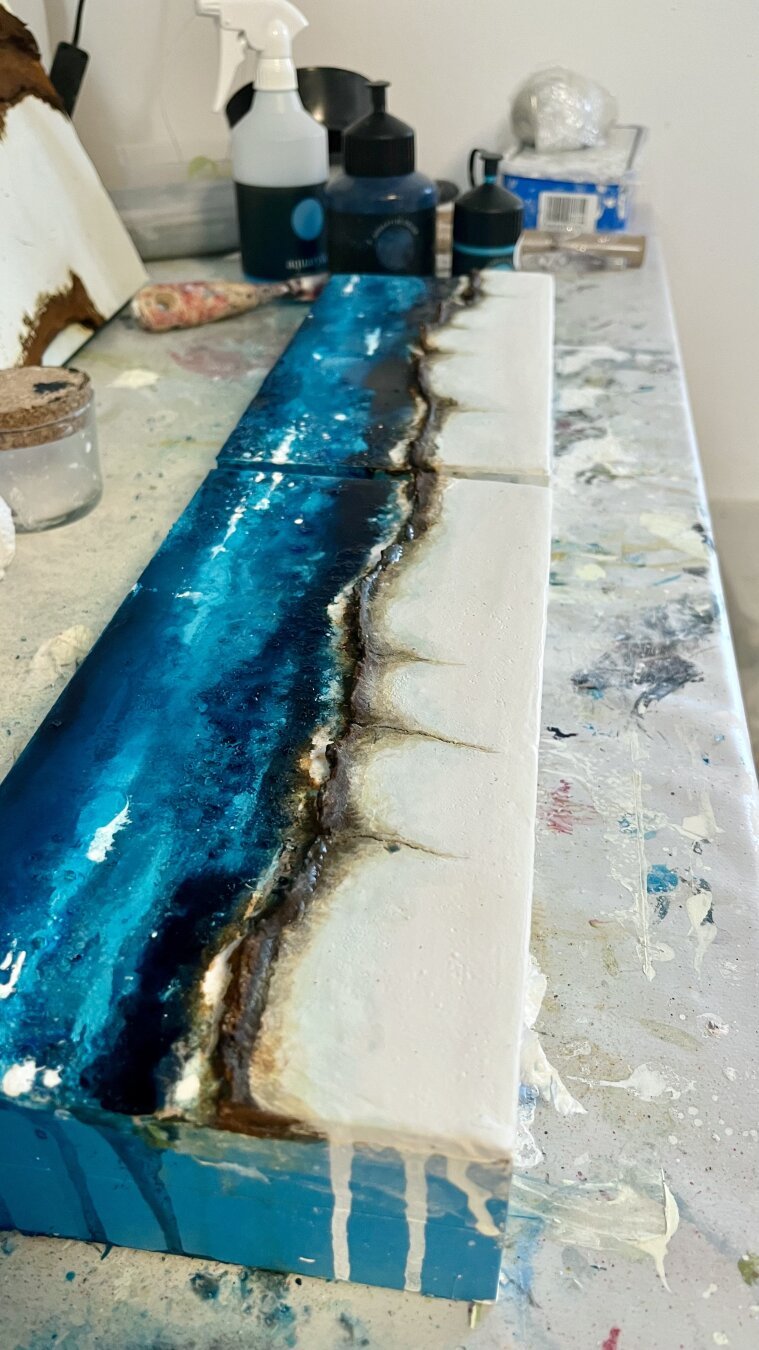 Zwei abstrakte, haptische Kunstwerke auf Holzpaneelen in gedeckten Farben, inspiriert von schottischen Küsten. Die reliefartige Struktur teilt die Bilder sichtbar und verleiht ihnen eine lebendige, fast dreidimensionale Wirkung. Meer, Klippen und raue Natur werden durch Farben und Texturen angedeutet.