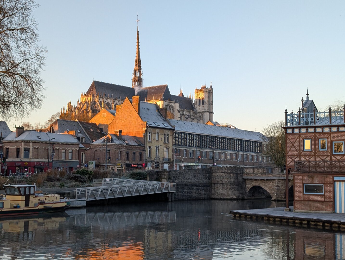 The cathedral of Amiens, during sunrise. In front, the river Somme.