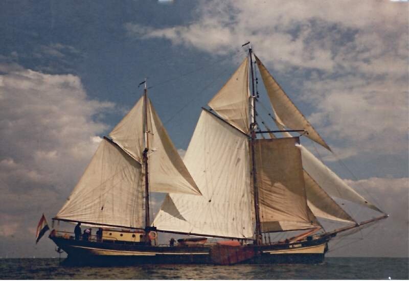 a very nice sailingboat in a calm sea - probapbly the Waddenzee in the north of the Netherlands - with a lot of sails and no wind at all