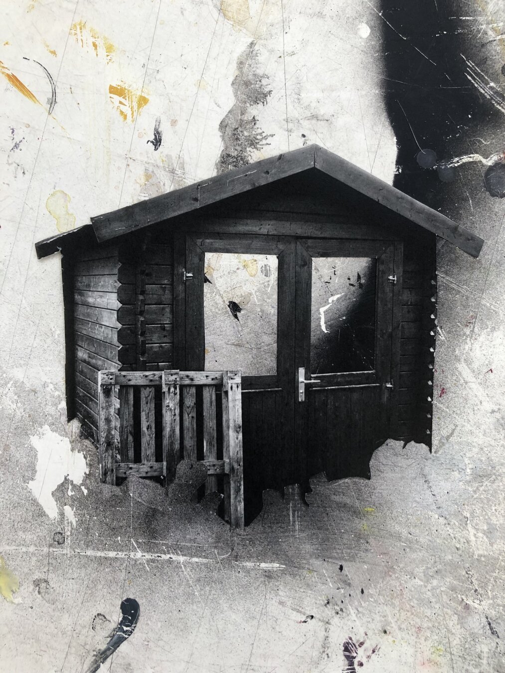 Cut out black and white image of wooden gardenshed on grayish and paintspotted background.