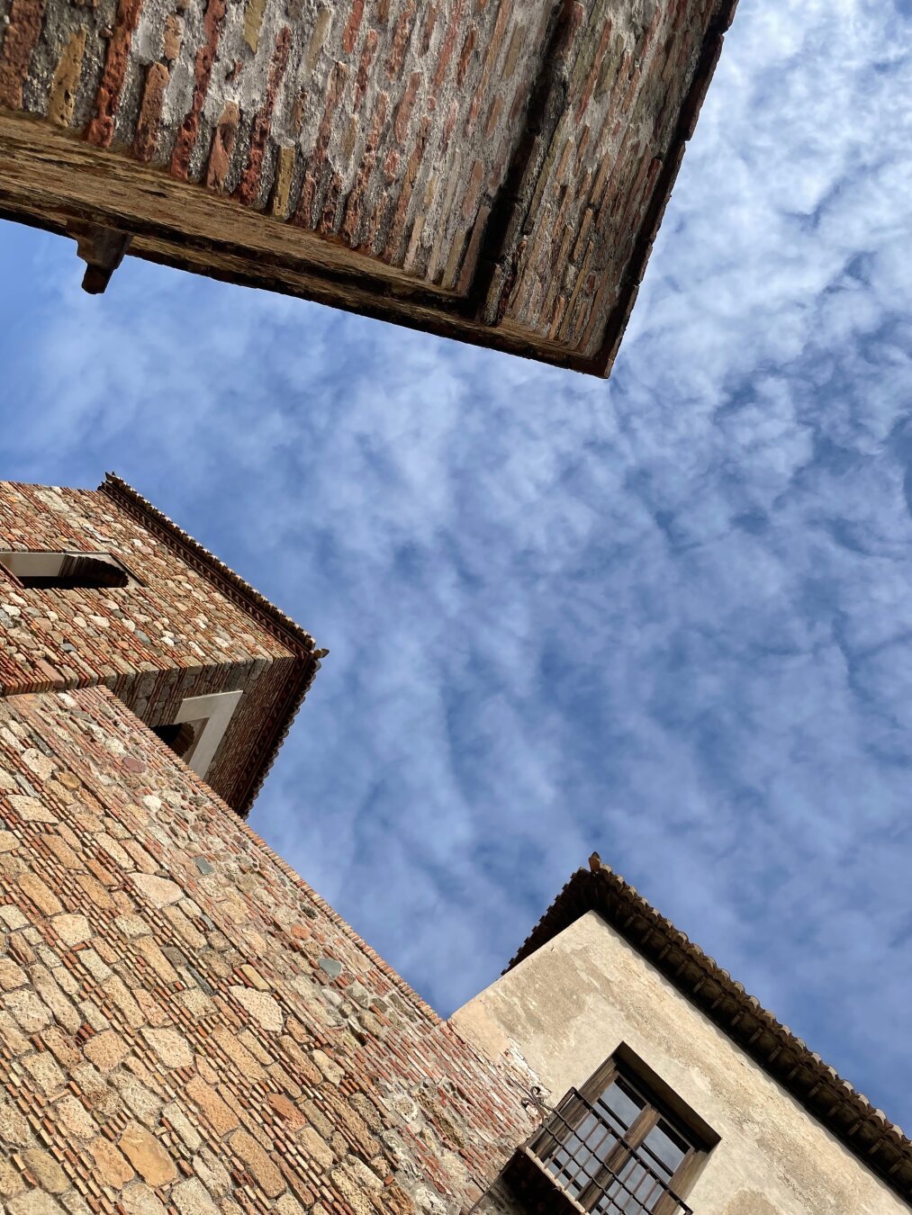 An upward shot showing several buildings of the Alcazaba palatial fortification in Malaga, Spain.