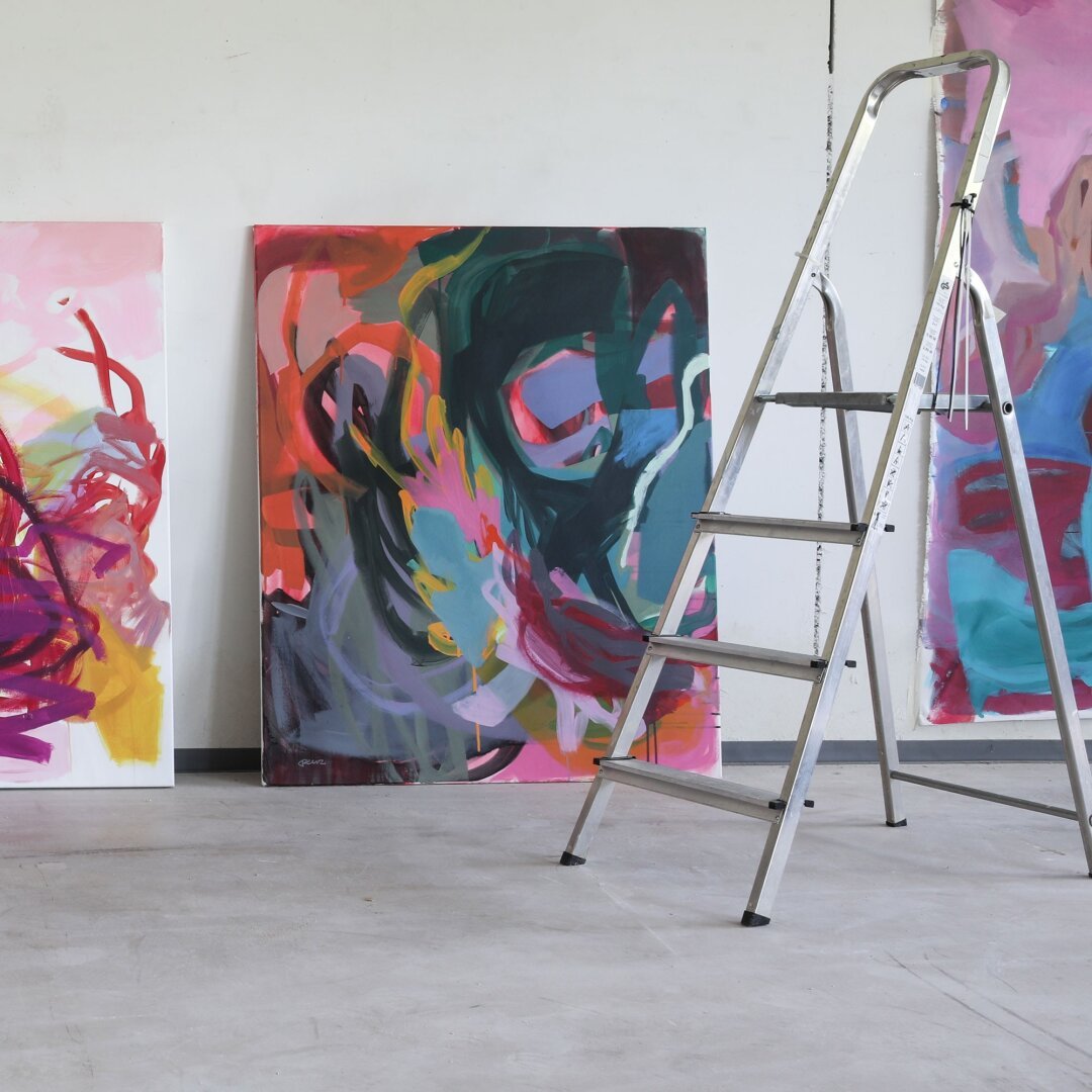 Abstract artworks in vibrant colors in large studio