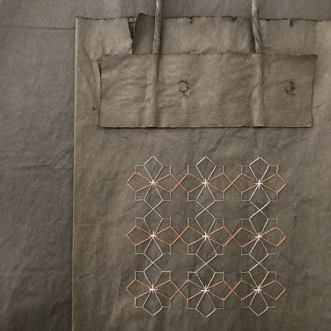 traditional sashiko style pattern stitched on a brown paper bag