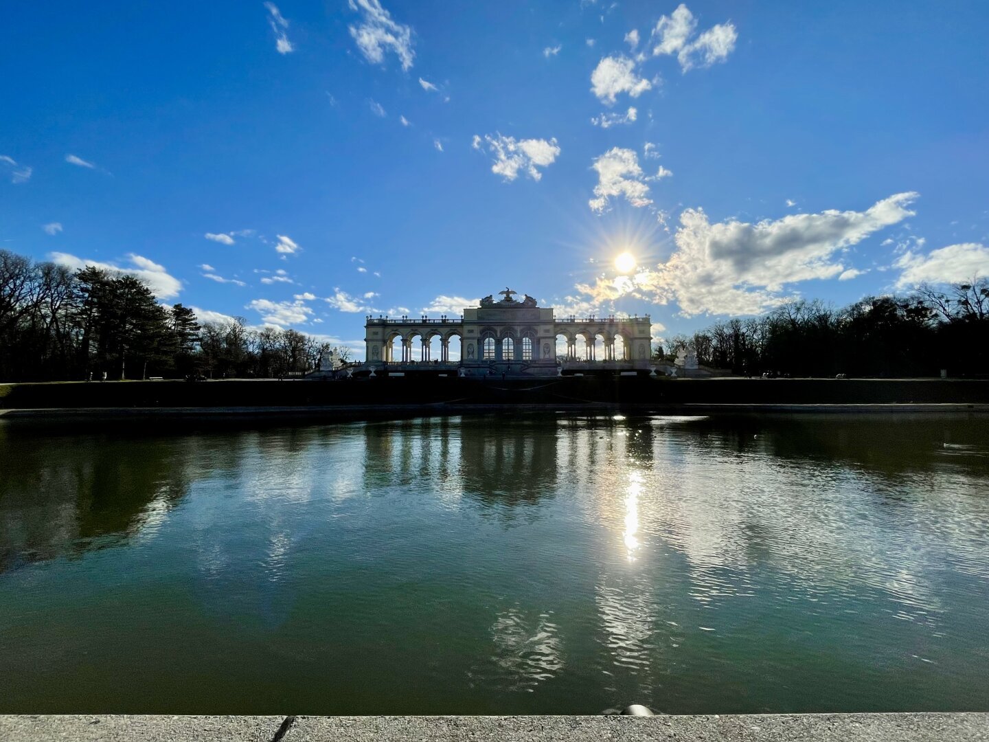 The Gloriette in Schönbrunn Palace Garden in Vienna, Austria under a sunny, blue sky.