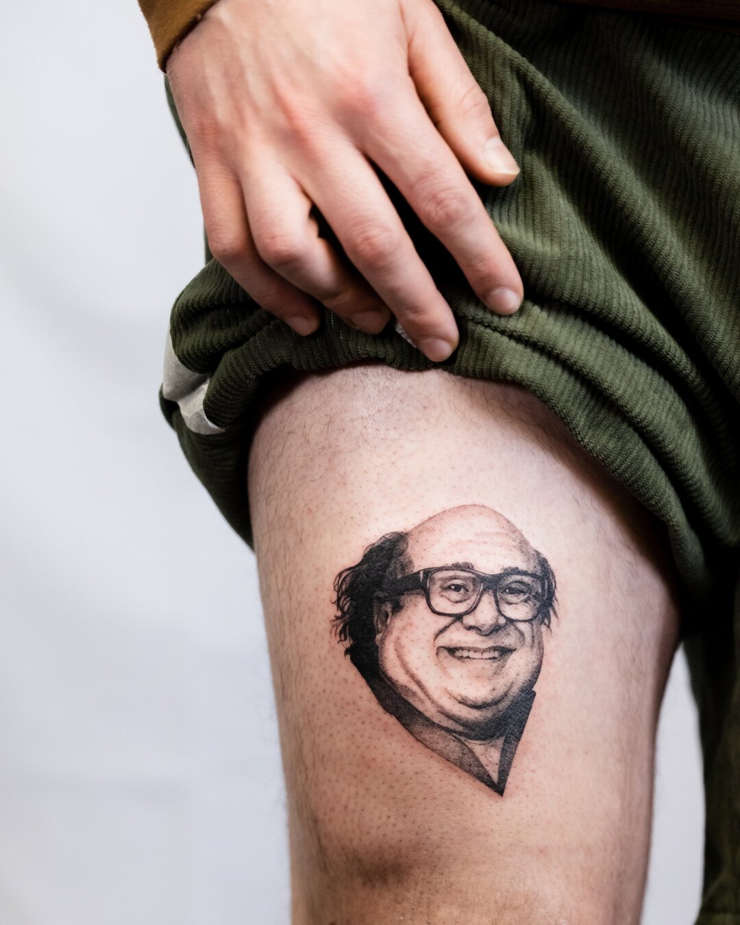 Black and grey tattoo portrait of Danny DeVito