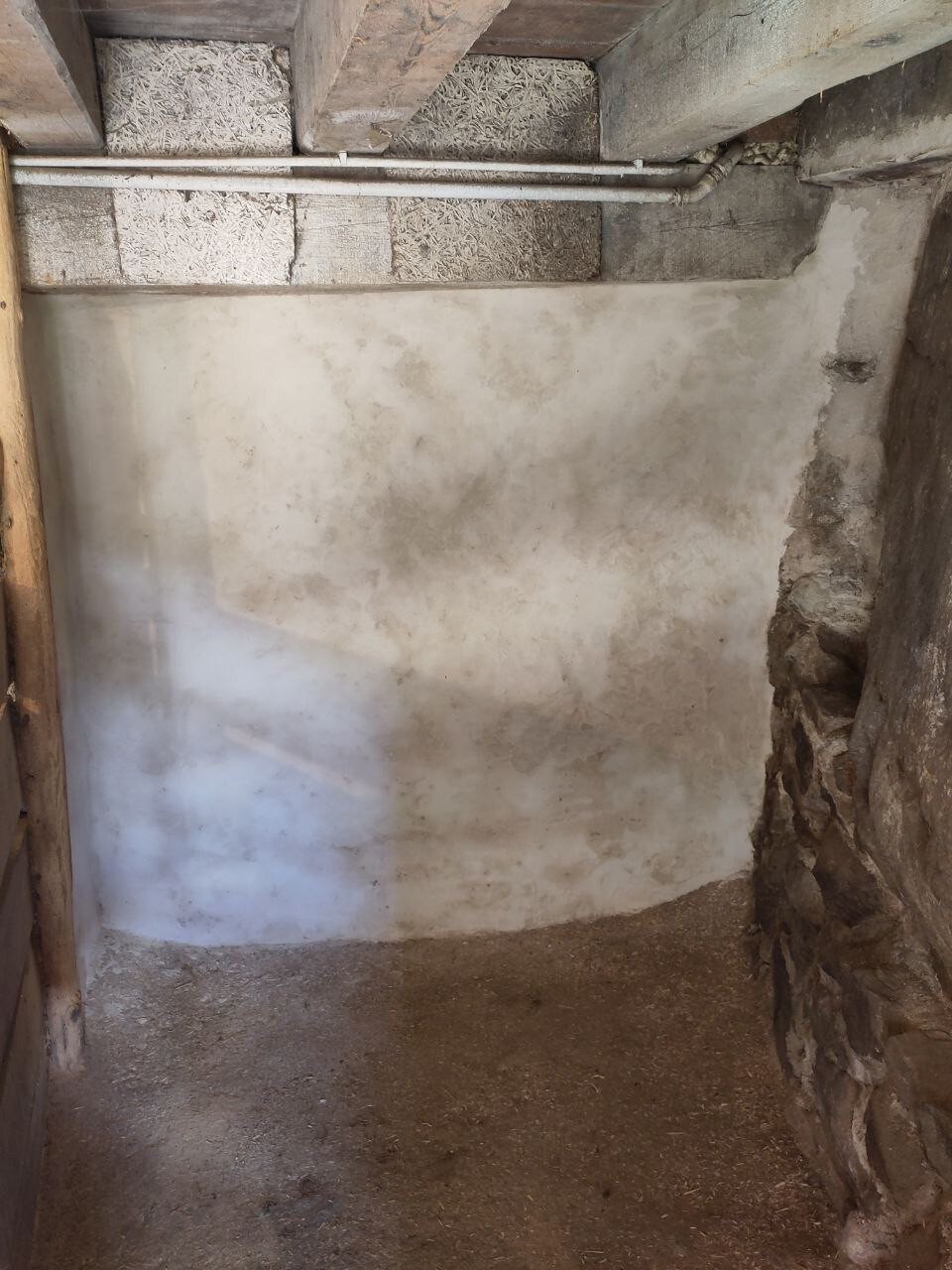 wall newly plastered with lime floor covered with stamped clay