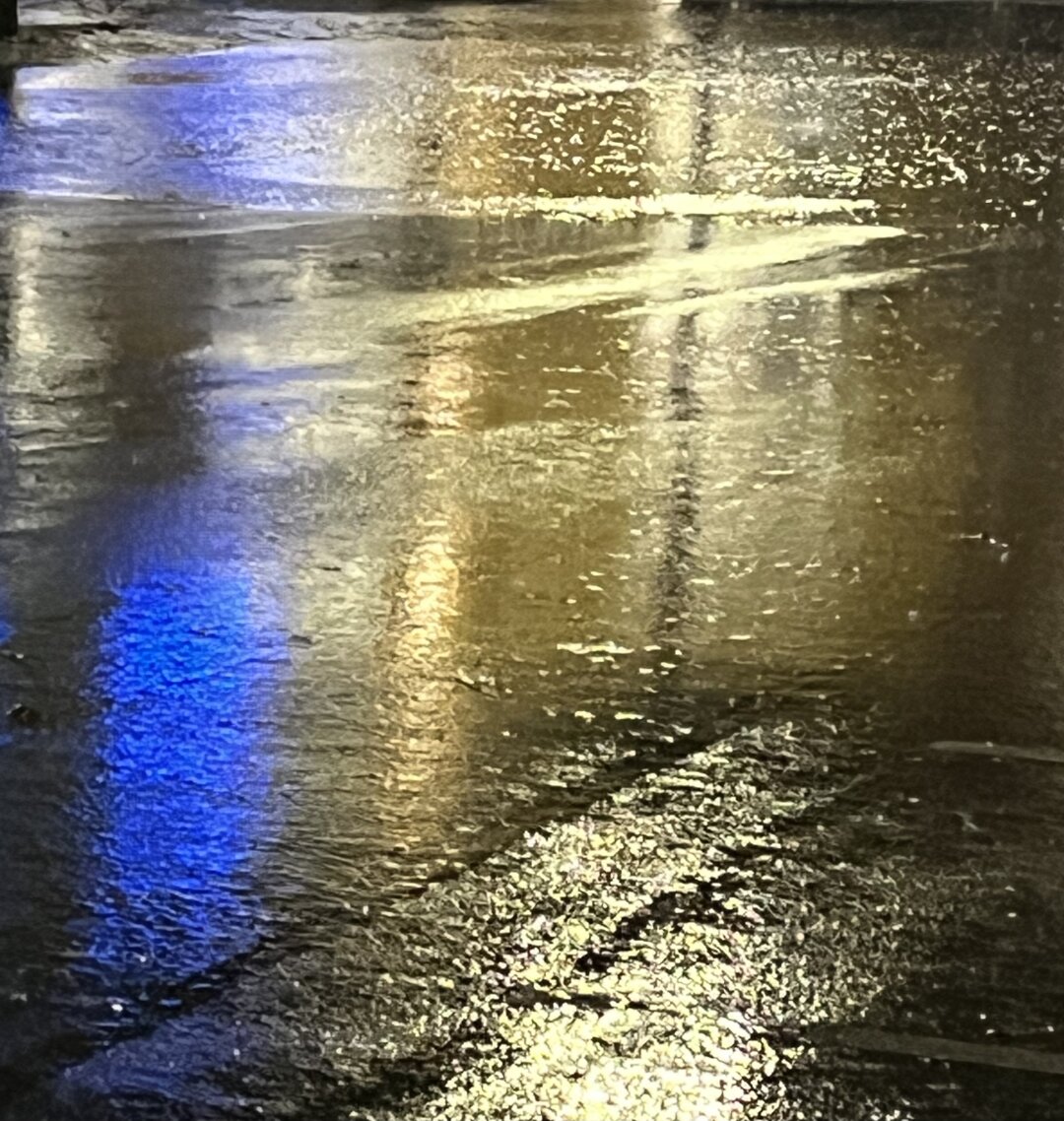 Light reflecting on standing water at night.