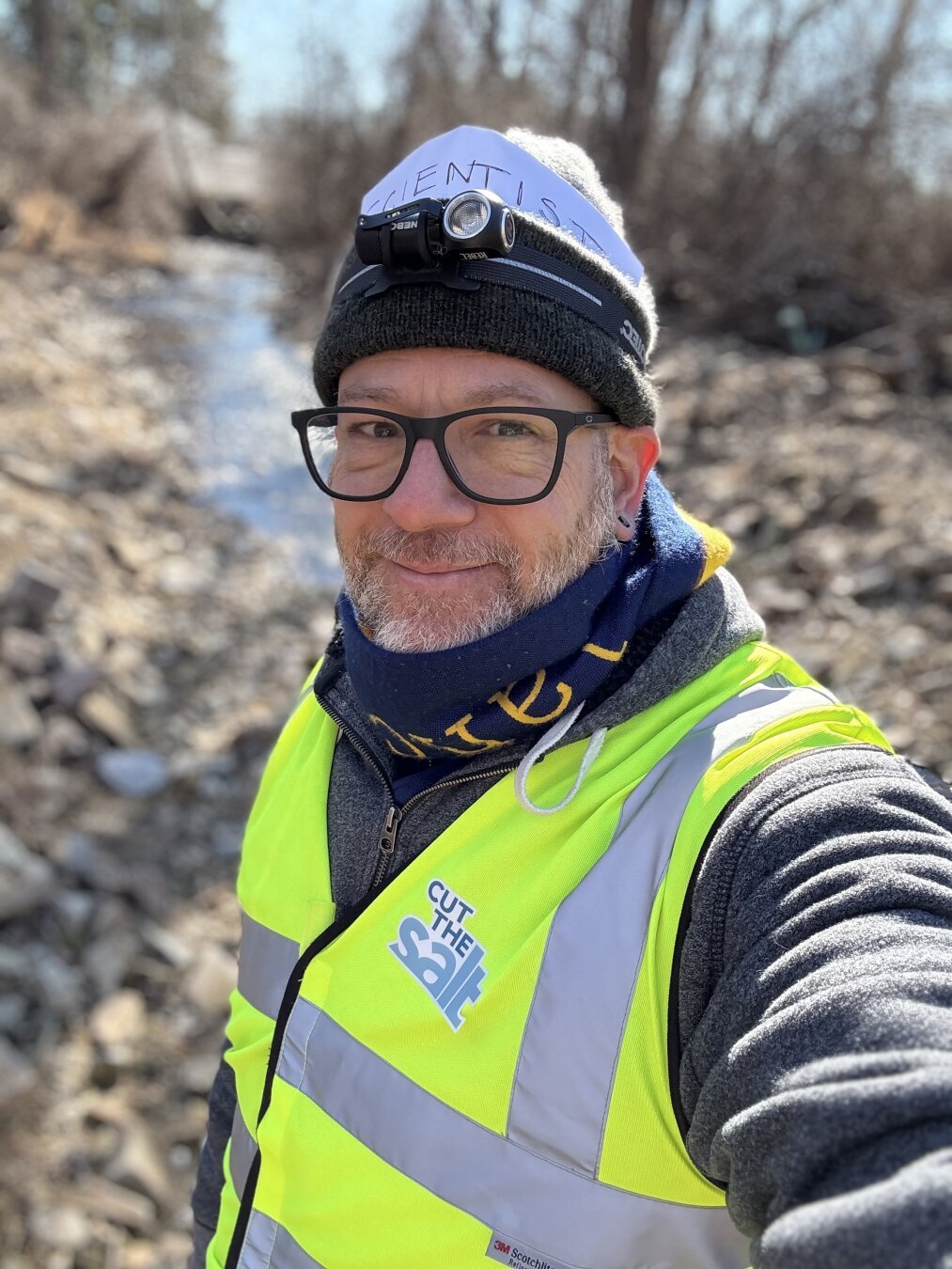 Liam Dempsey standing next to a creek