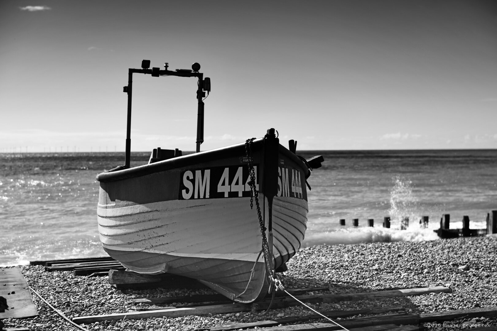 Monochrome photo of a fishing boat on Worthing beach.