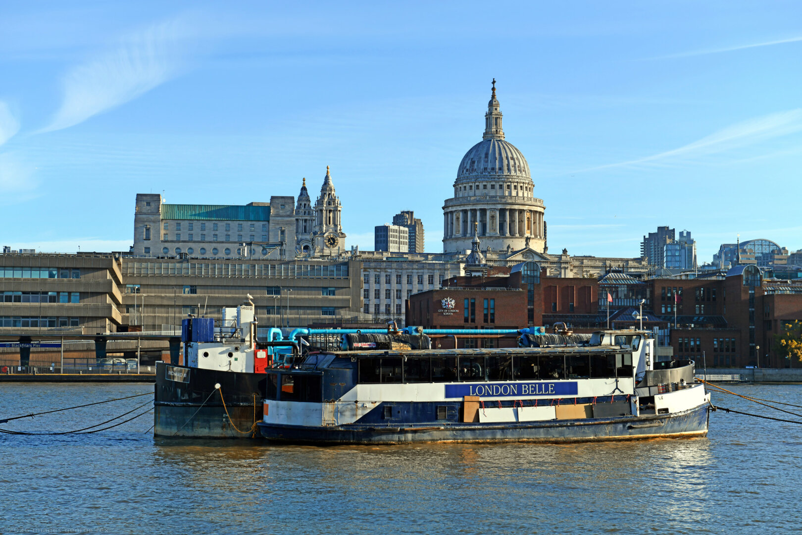 Photo of the river Thames seen from the London Borough of Southwark. London Belle at the front was built by Rowhedge Iron Works in 1948 as an excursion boat, although retired by London Party Boats last year I believe. Richard III behind is a waste pump-out barge. Dome of Wren's St Paul's Cathedral in background.