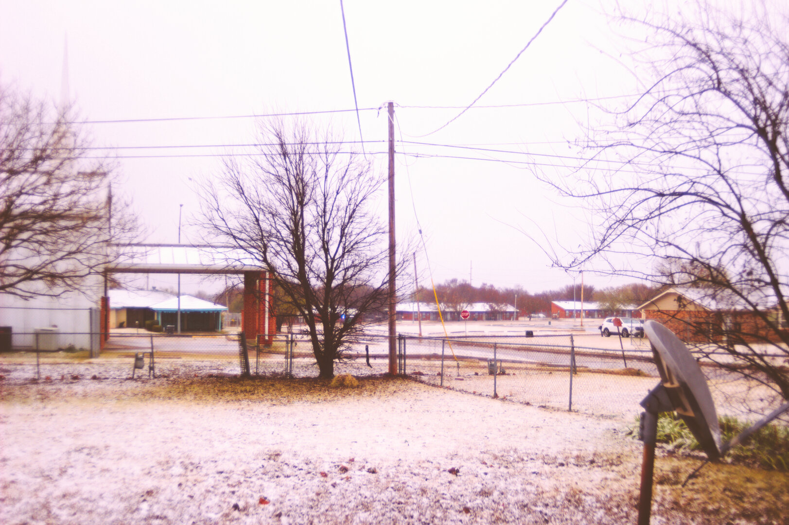 It started snowing here in Lawton. This was photographed through an EOS Rebel T3i with a Vivitar Series 1 19-35mm f3.5-4.5 FD-mount zoom lens and I applied a Polaroid 590 5++ film sim filter to it.