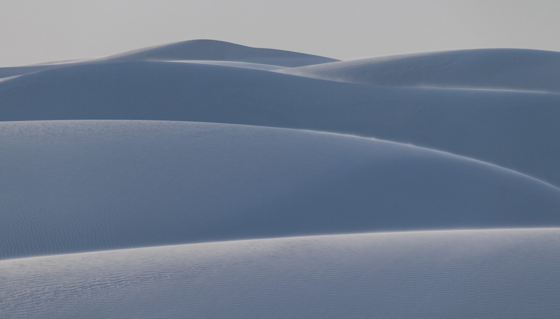 Heaps of sand dunes, bluish in color.